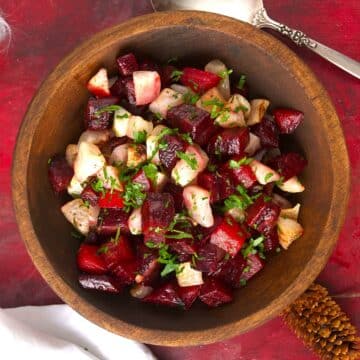 Roasted beets and turnips in wooden serving bowl.