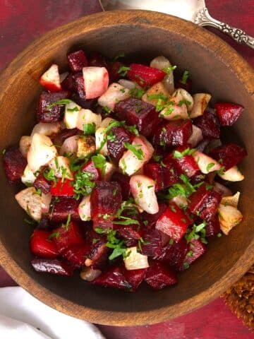 Roasted beets and turnips in wooden serving bowl.