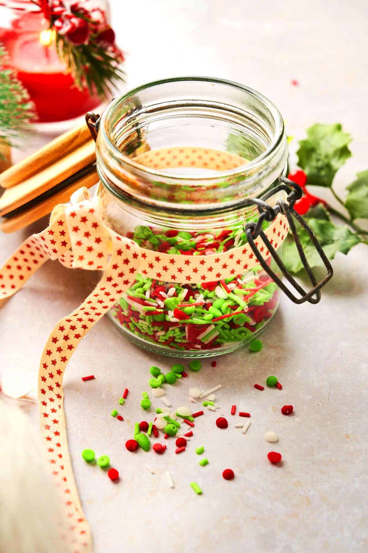 Christmas candy sprinkles in decorated jar.