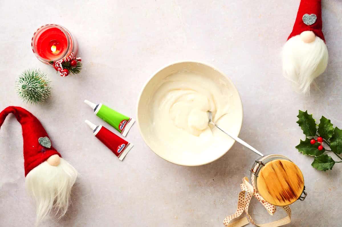 Frosting mixture in small bowl with spoon.