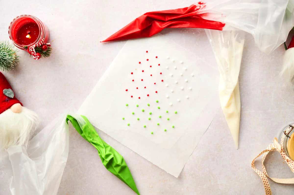 Christmas candy dots drying on wax paper.