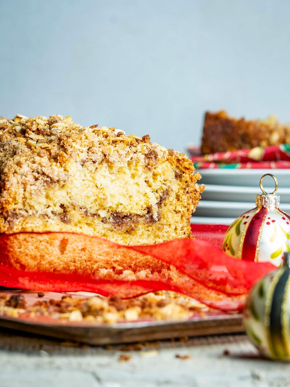 Sliced coffee cake loaf with Christmas decorations.