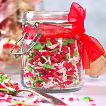 Christmas sprinkles in jar with red ribbon.