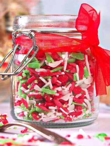 Christmas sprinkles in jar with red ribbon.
