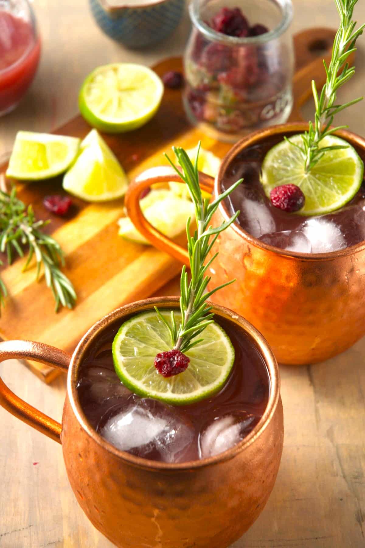Cranberry ginger Moscow mule in copper mugs with dried cranberries.