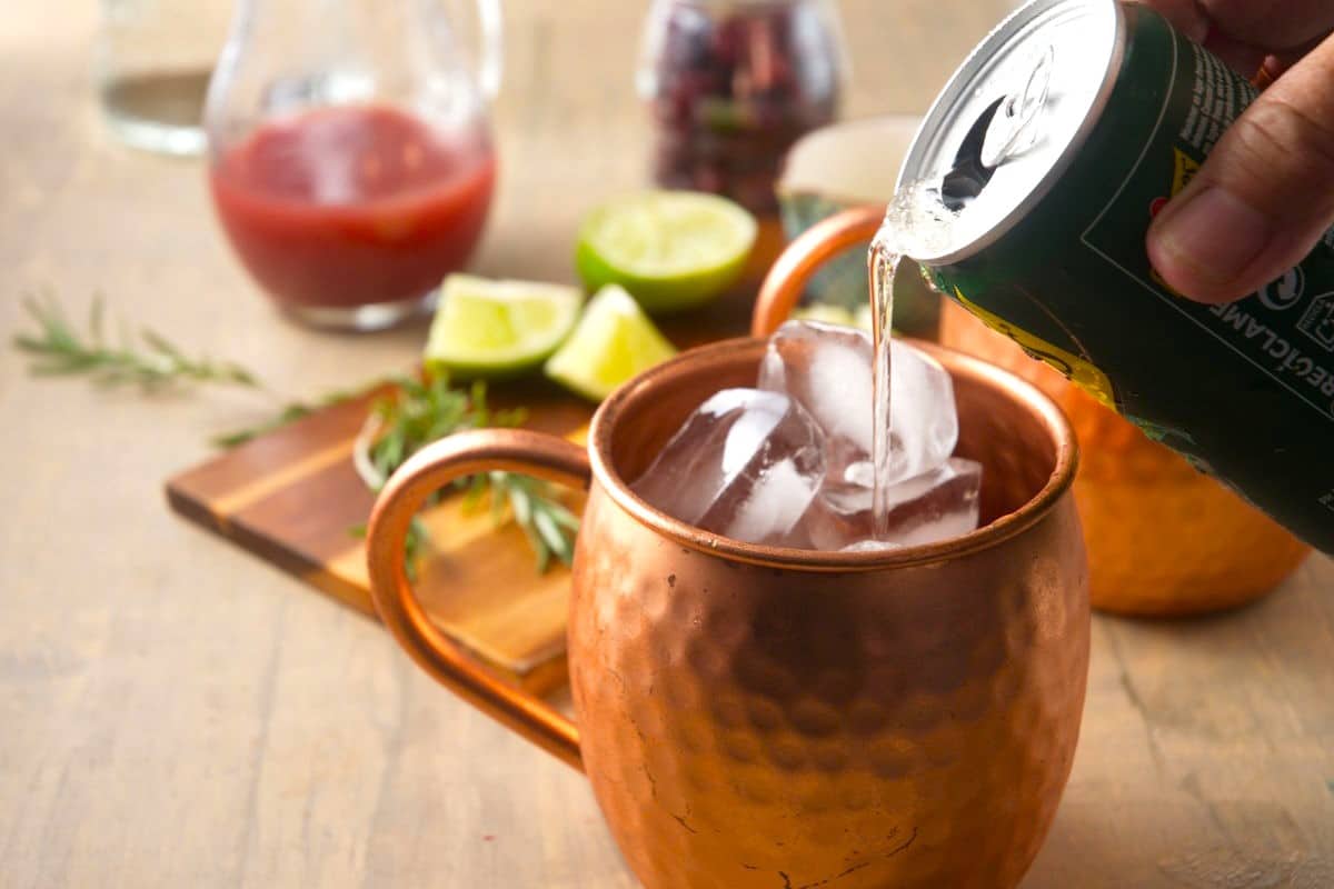 Ginger beer and ice in copper mug.