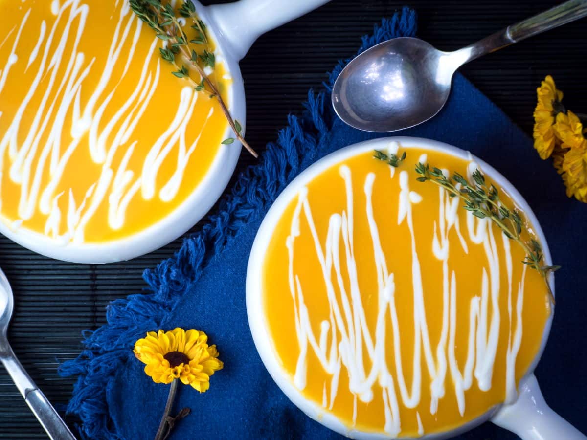 Pumpkin soup in white porcelain soup bowls.