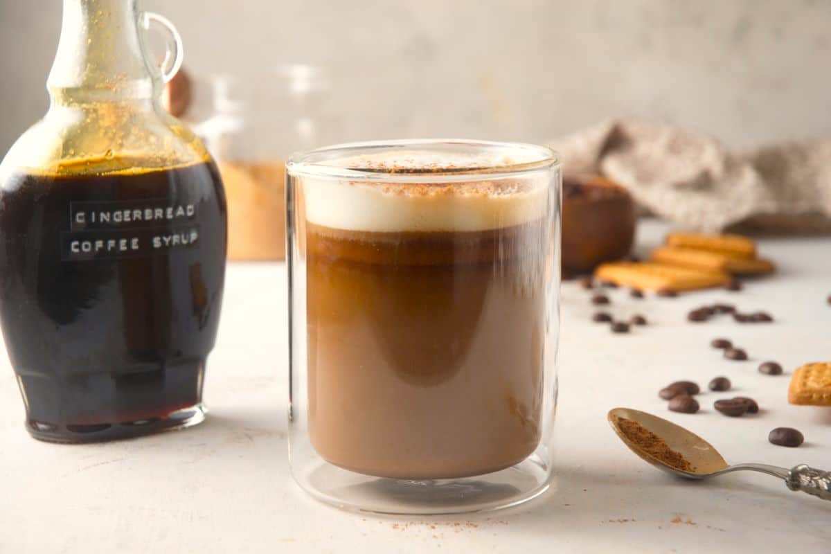 Gingerbread syrup and latte in a mug with spoon on the side.