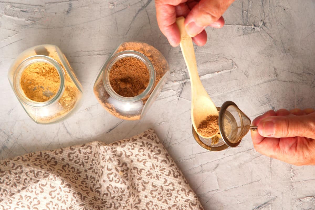 Spices in small jars and a tea infuser.
