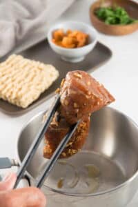 Marinated pork tenderloin and a large pot.