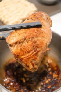 Seared pork tenderloin in a large pot.