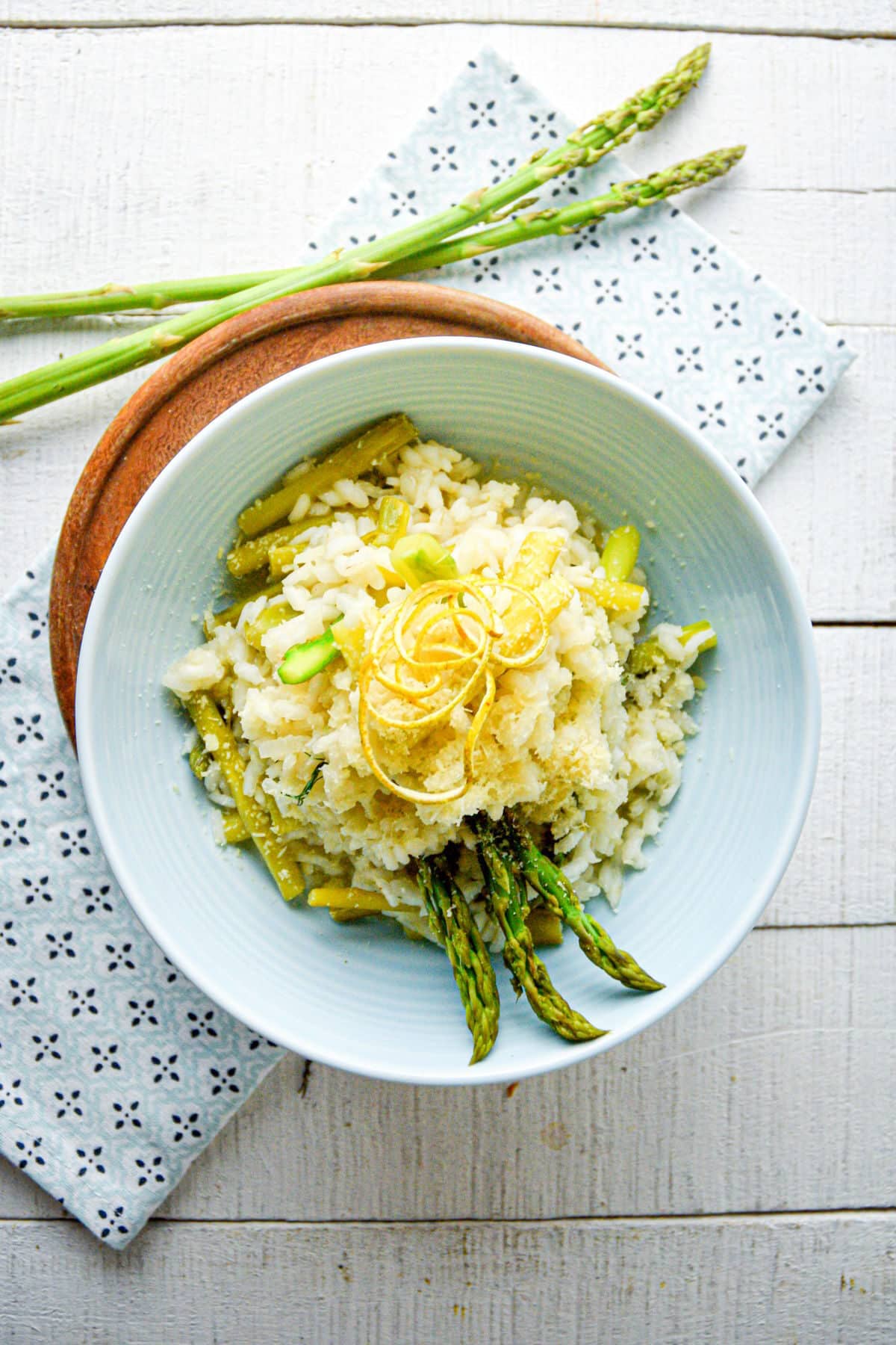 Asparagus risotto in bowl on white wooden backgroudn.