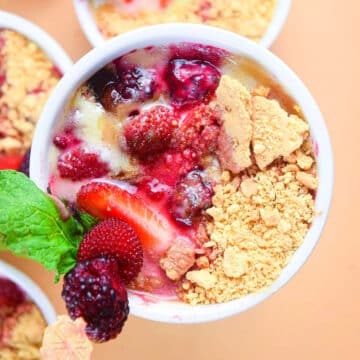 Berries and cream in a ramekin.