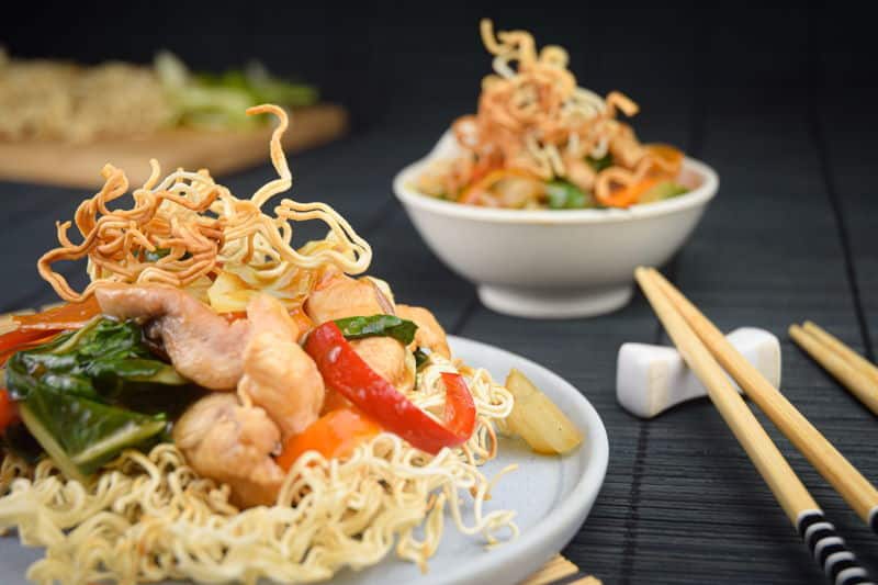 Crunchy chow mein noodles with chopsticks.