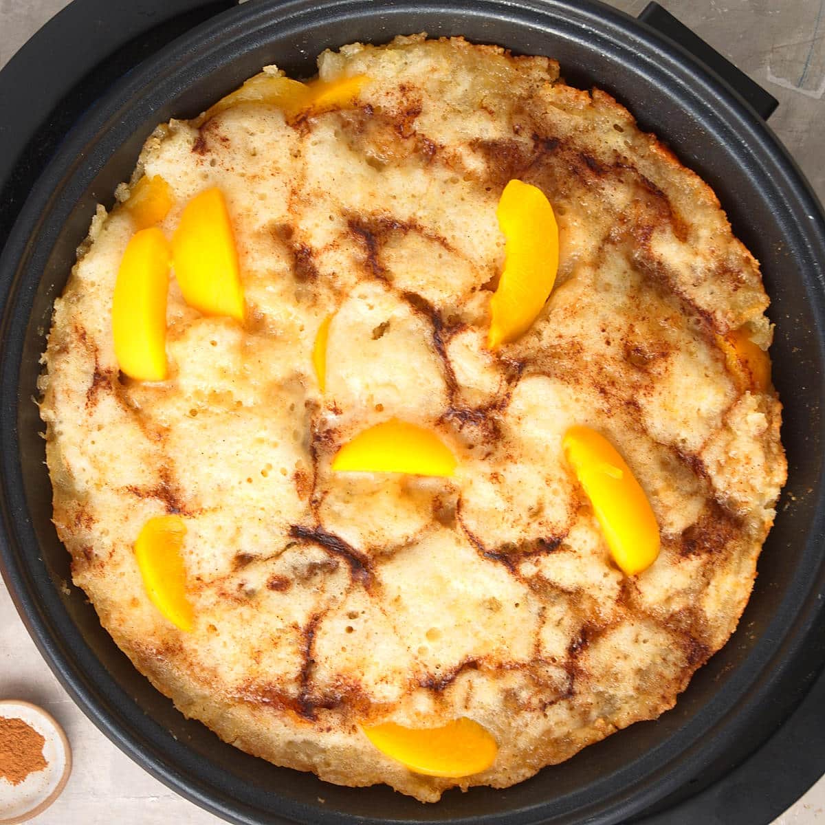 Peach cobbler in electric skillet.