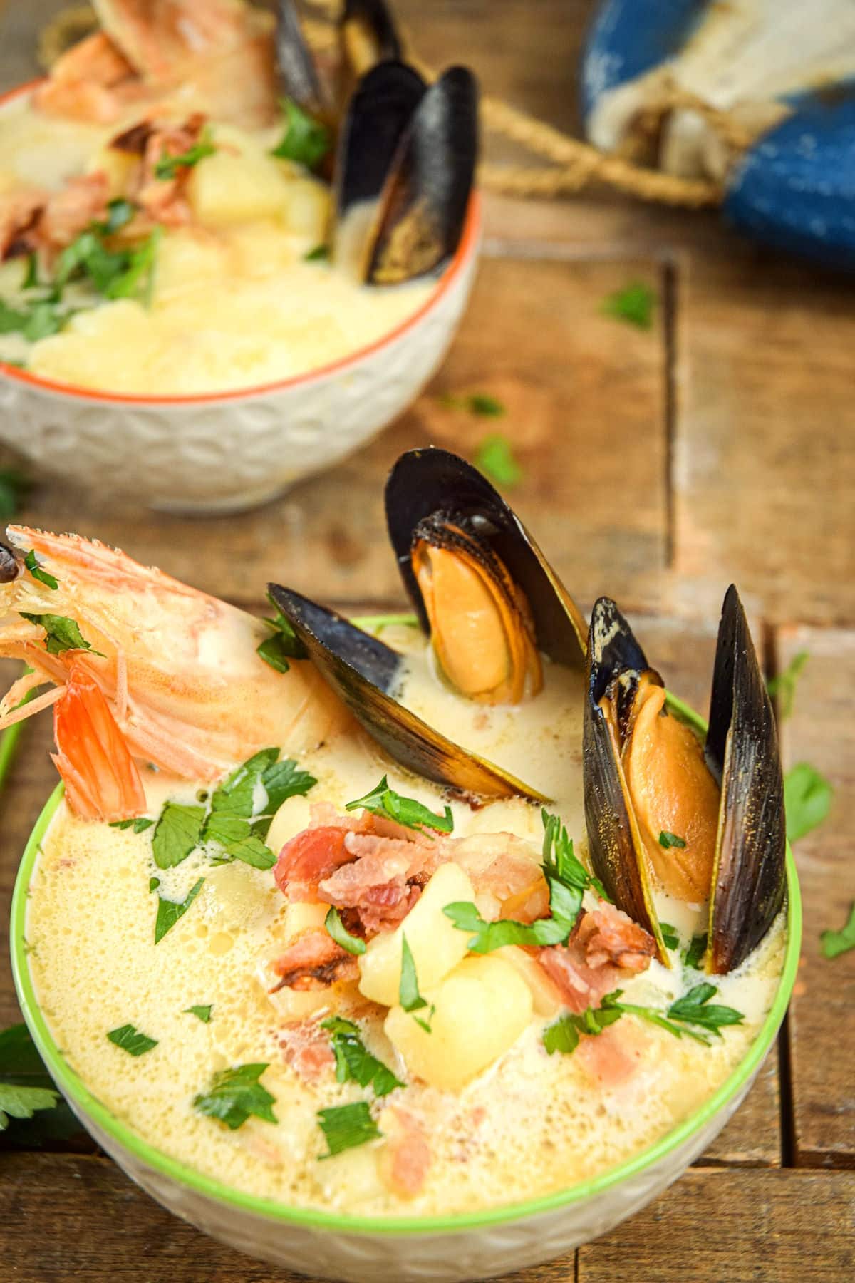 Seafood chowder in bowl with fresh parsley.