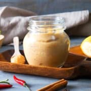 Banana ketchup in a small jar and on a small spoon.