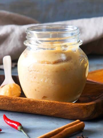 Banana ketchup in a small jar and on a small spoon.