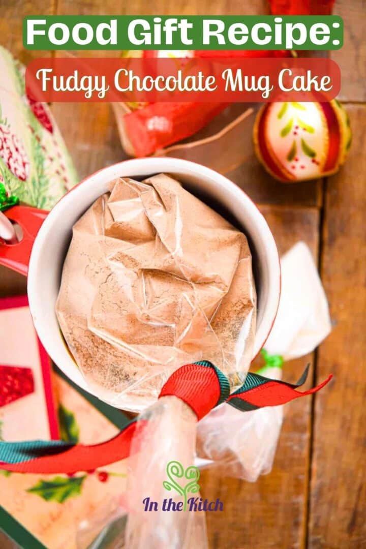 Mug cake powder mix in a bag in a mug with Christmas decorations.