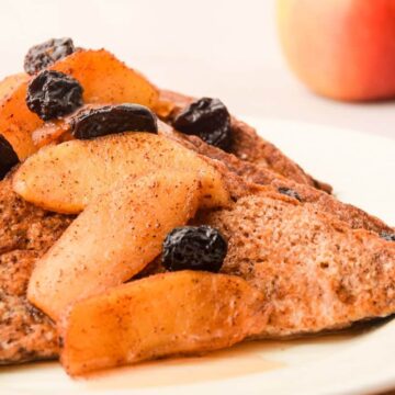 French Toast with Cinnamon Apple Garnish on a white plate.