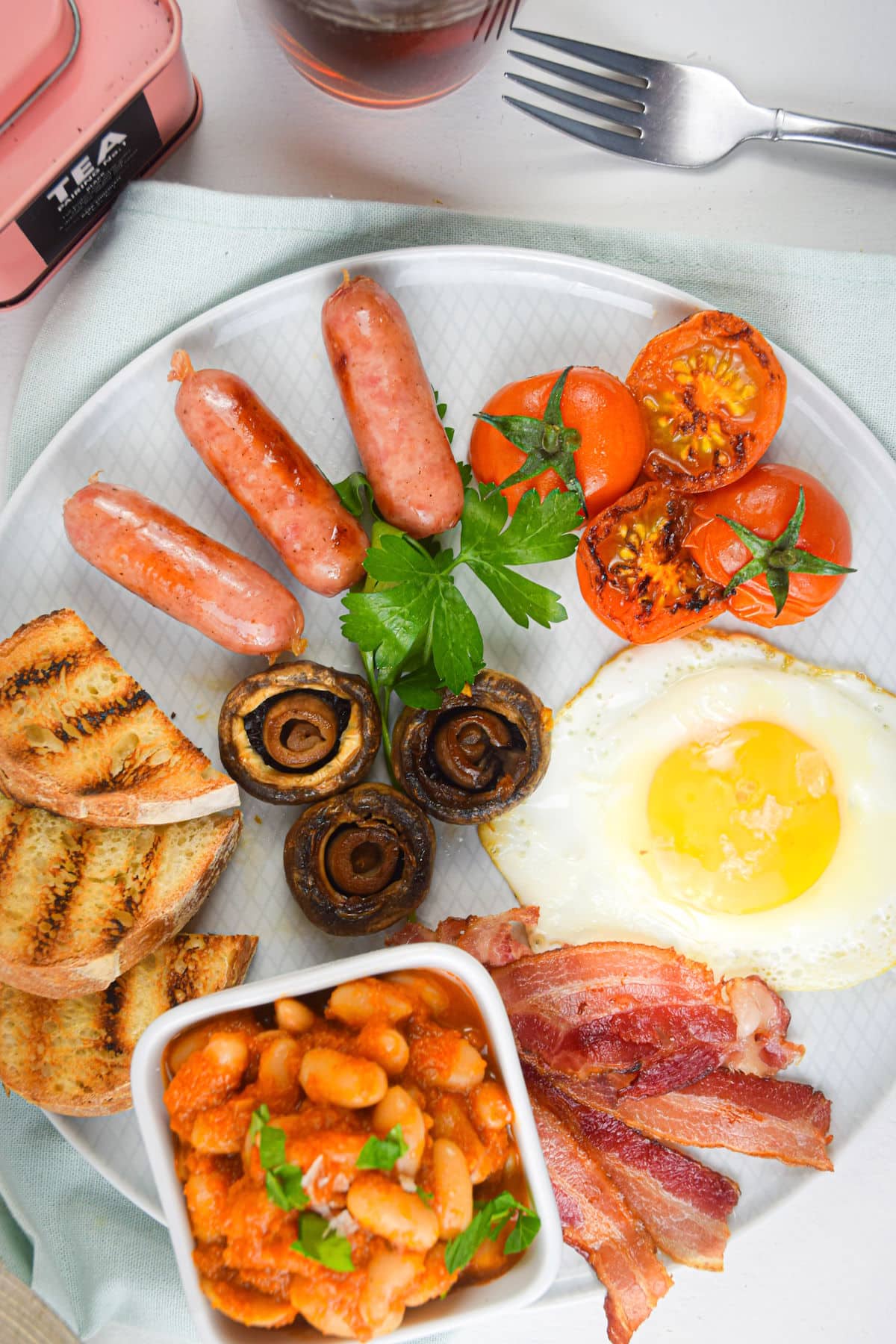 Full English breakfast on white plate and white backgrouond.