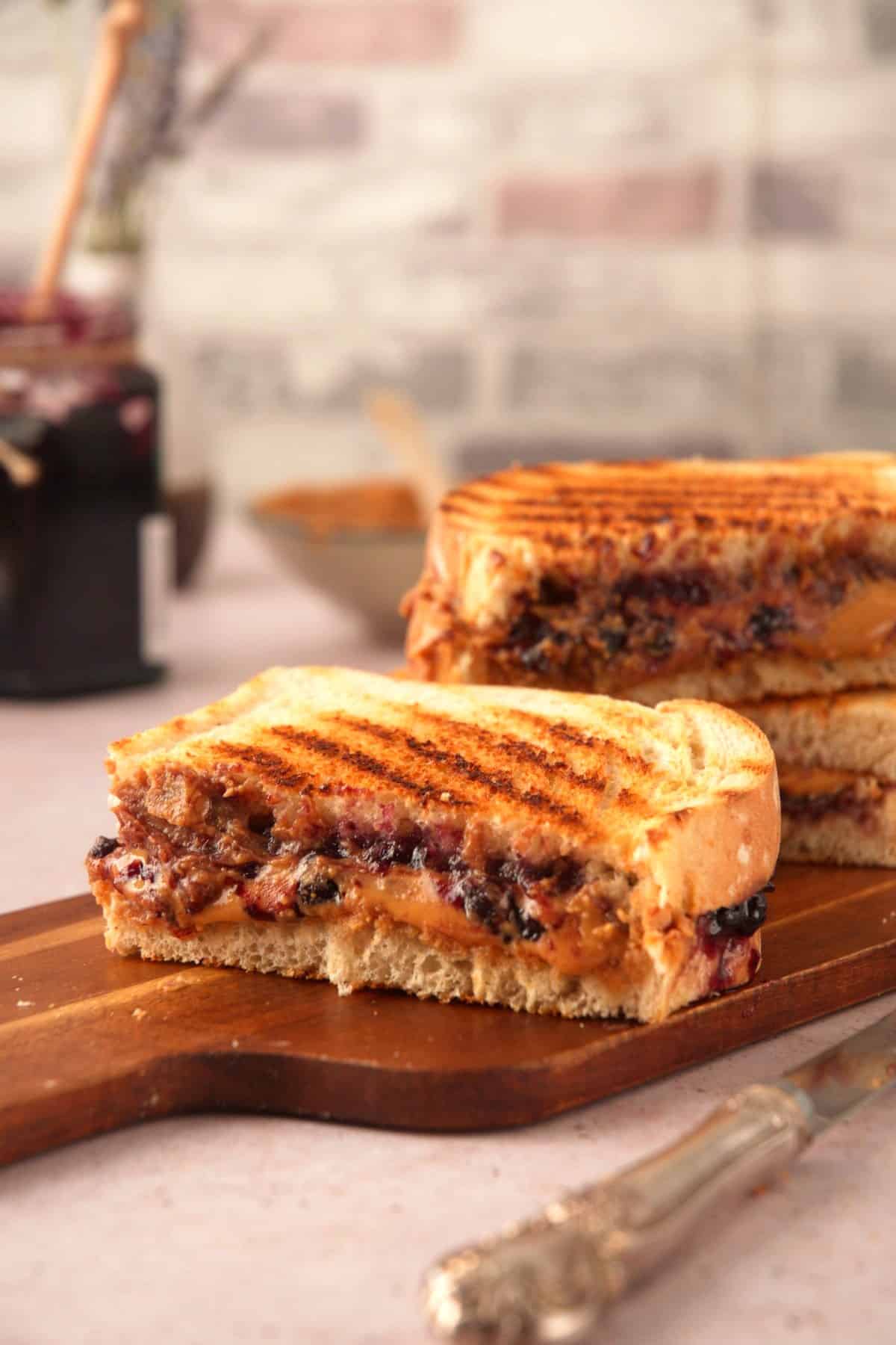 Grilled PBJ sandwiches on cutting board.