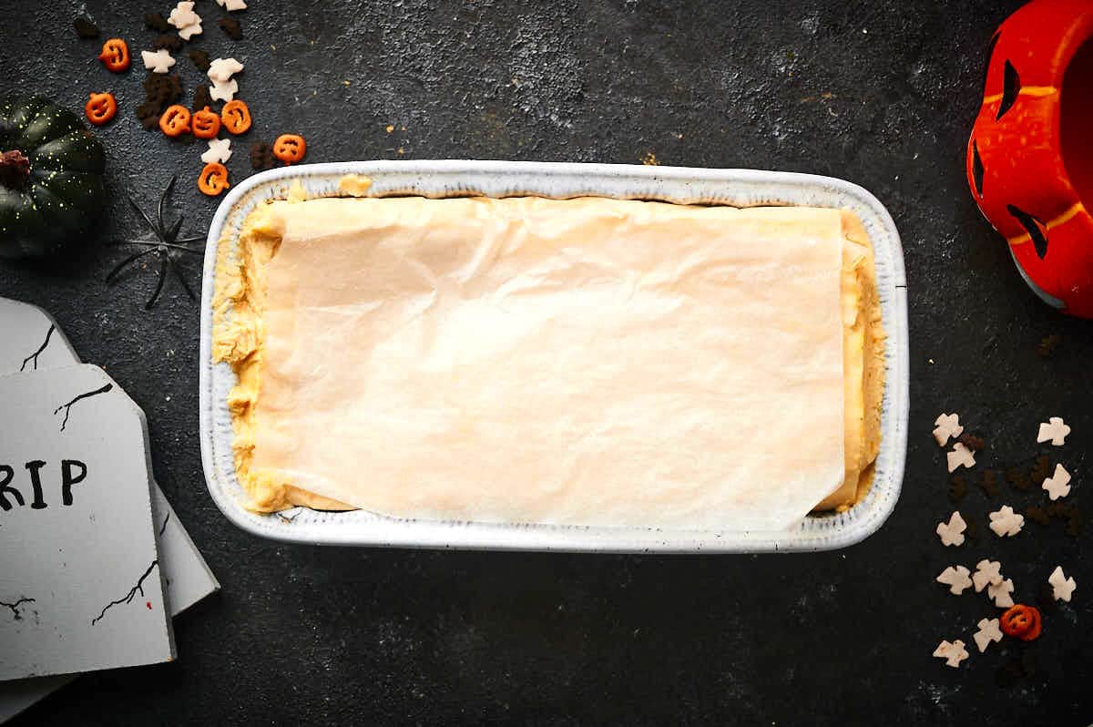 Halloween ice cream in loaf pan with wax paper.