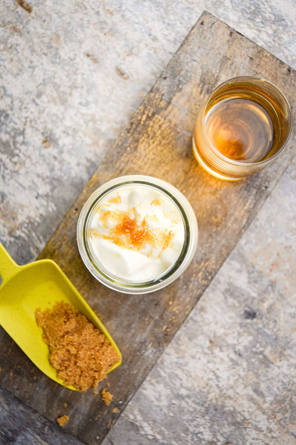 Homemade whipped topping with brown sugar and bourbon in small jar.