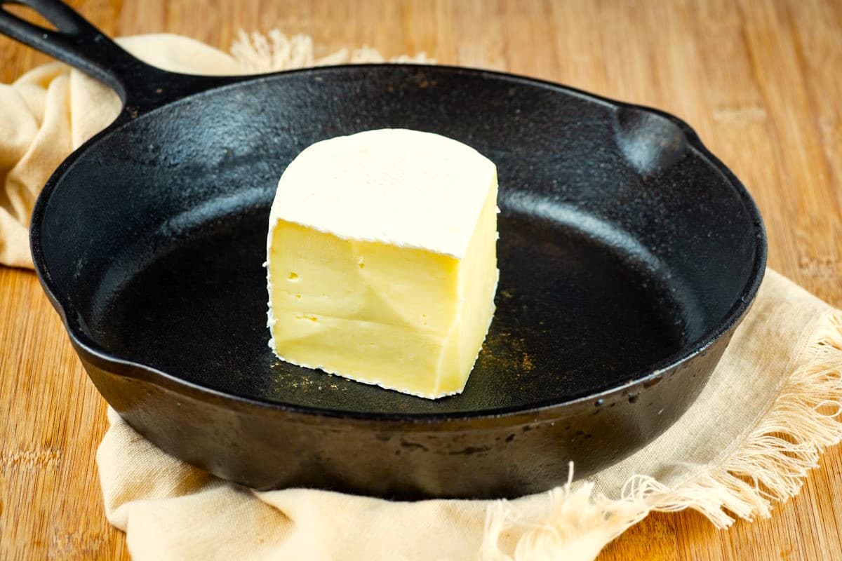 Brie wedge in cast iron pan.