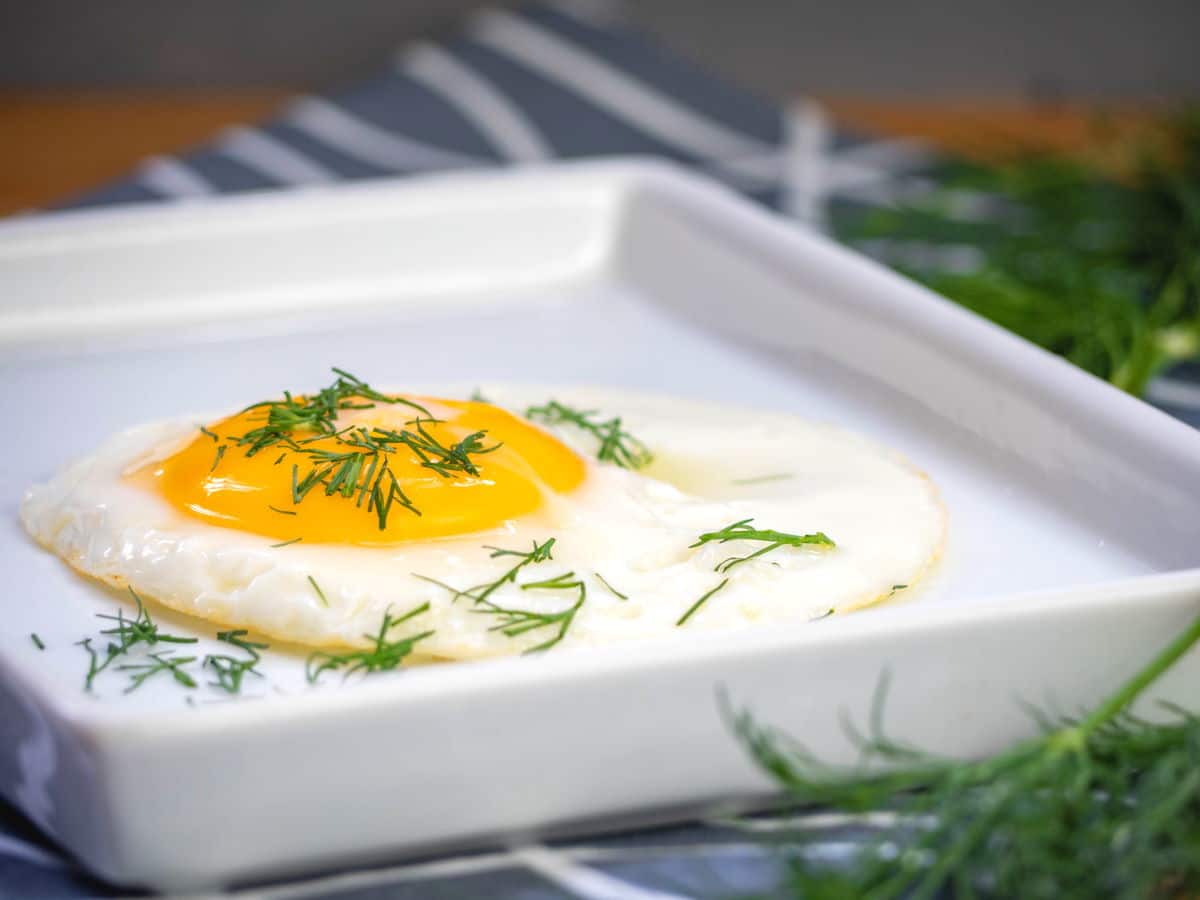 How to Chop Dill - Sample Prep 1 Fried egg on white plate with chopped dill.