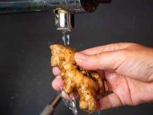Ginger root under running water.