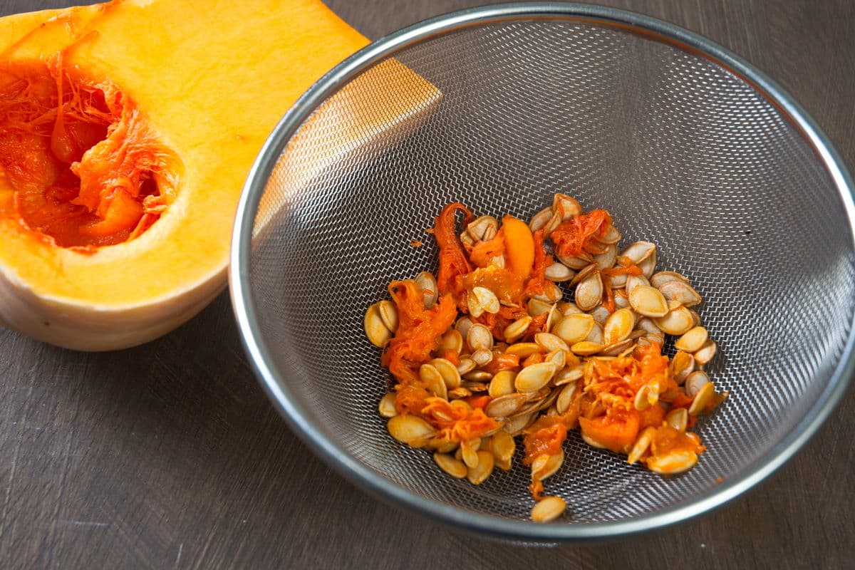 Butternut squash seeds in a sieve.