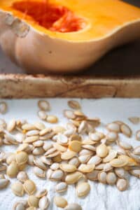 Butternut squash seeds drying on a paper towel.