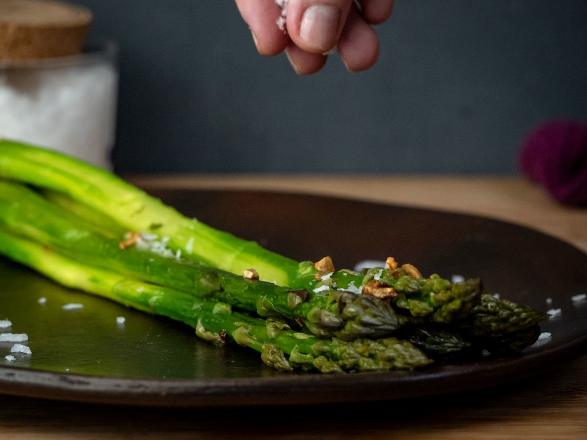 How to Cook Asparagus on the Stove - Step 9 Asparagus on plate with flake salt.