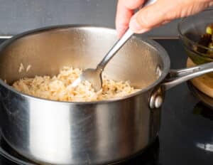 Brown rice in pot with fork.
