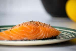 Seasoned salmon fillet on plate.