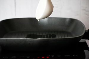 Oil in grill pan on stove.