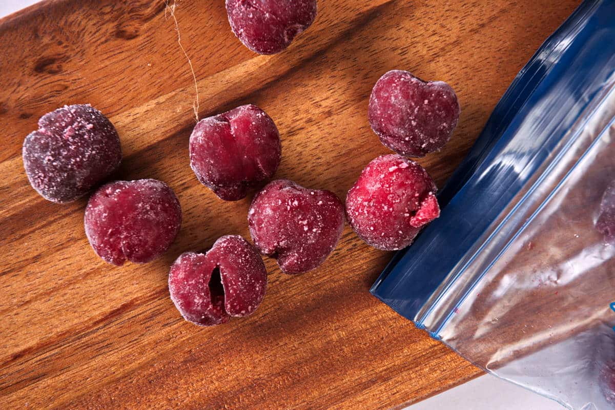 Frozen cherries on wooden board.