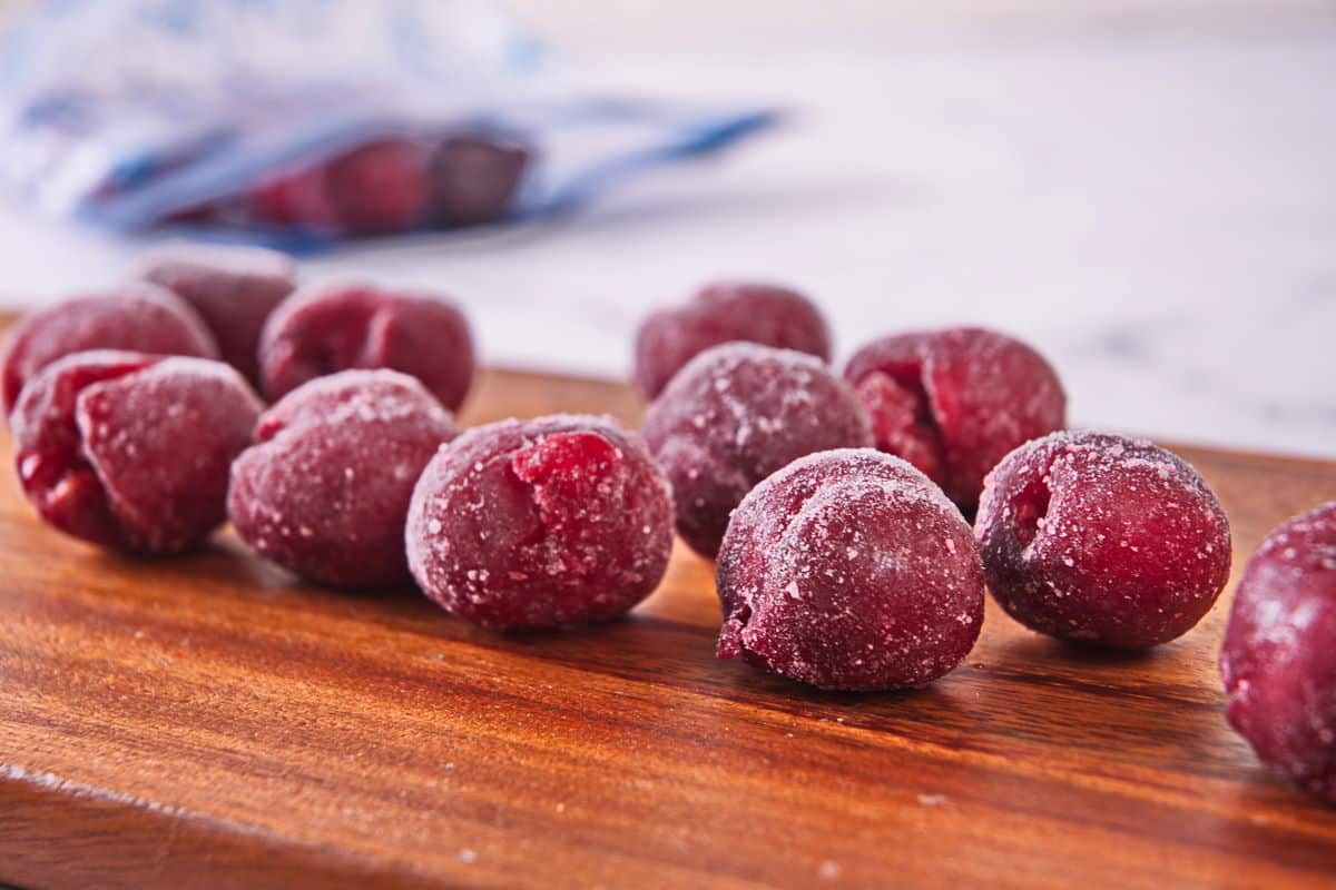 Frozen cherries on wooden board.