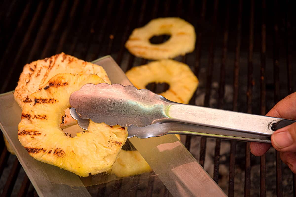 How to Grill Pineapple Slices_11 Pineapple slices on grill and serving dish.