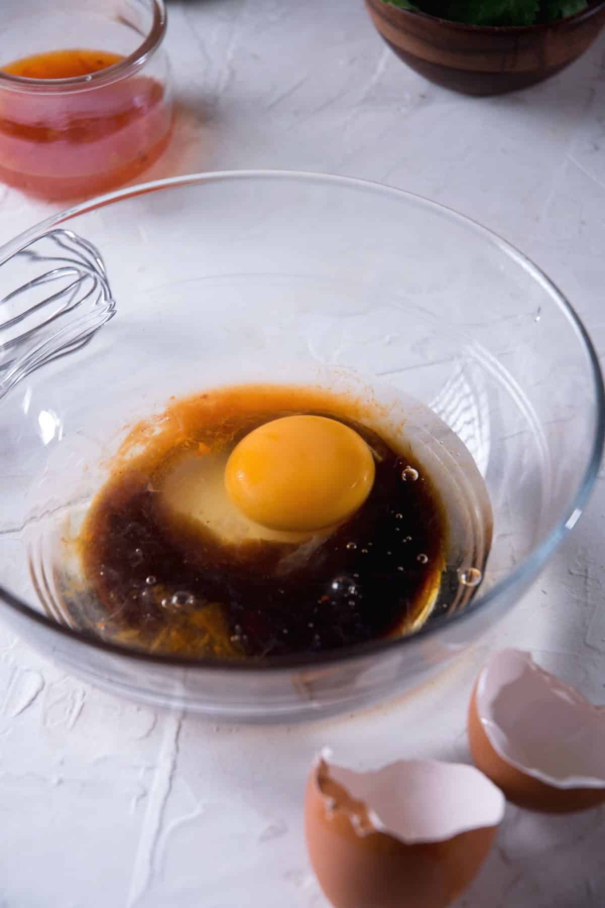 Liquid kimchi batter ingredients in a glass bowl.