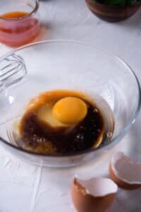 Liquid kimchi batter ingredients in a glass bowl.