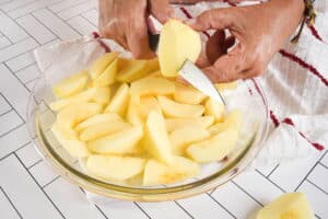 Sliced apples in pie dish.