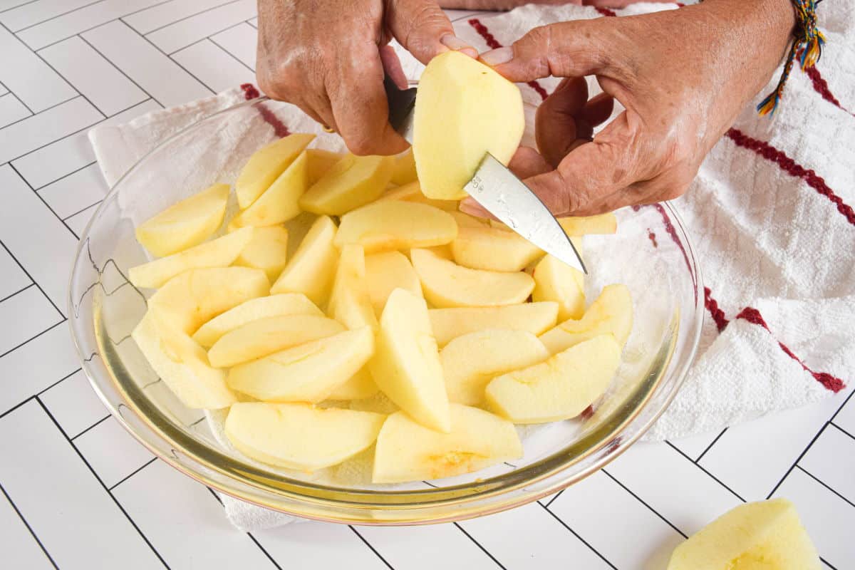 Sliced apples in pie dish.