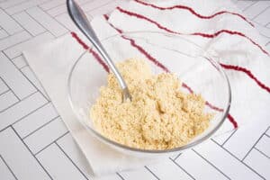 Apple crisp crumble in bowl with spoon.