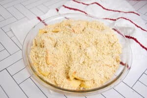 Unbaked apple crisp in a pie dish.