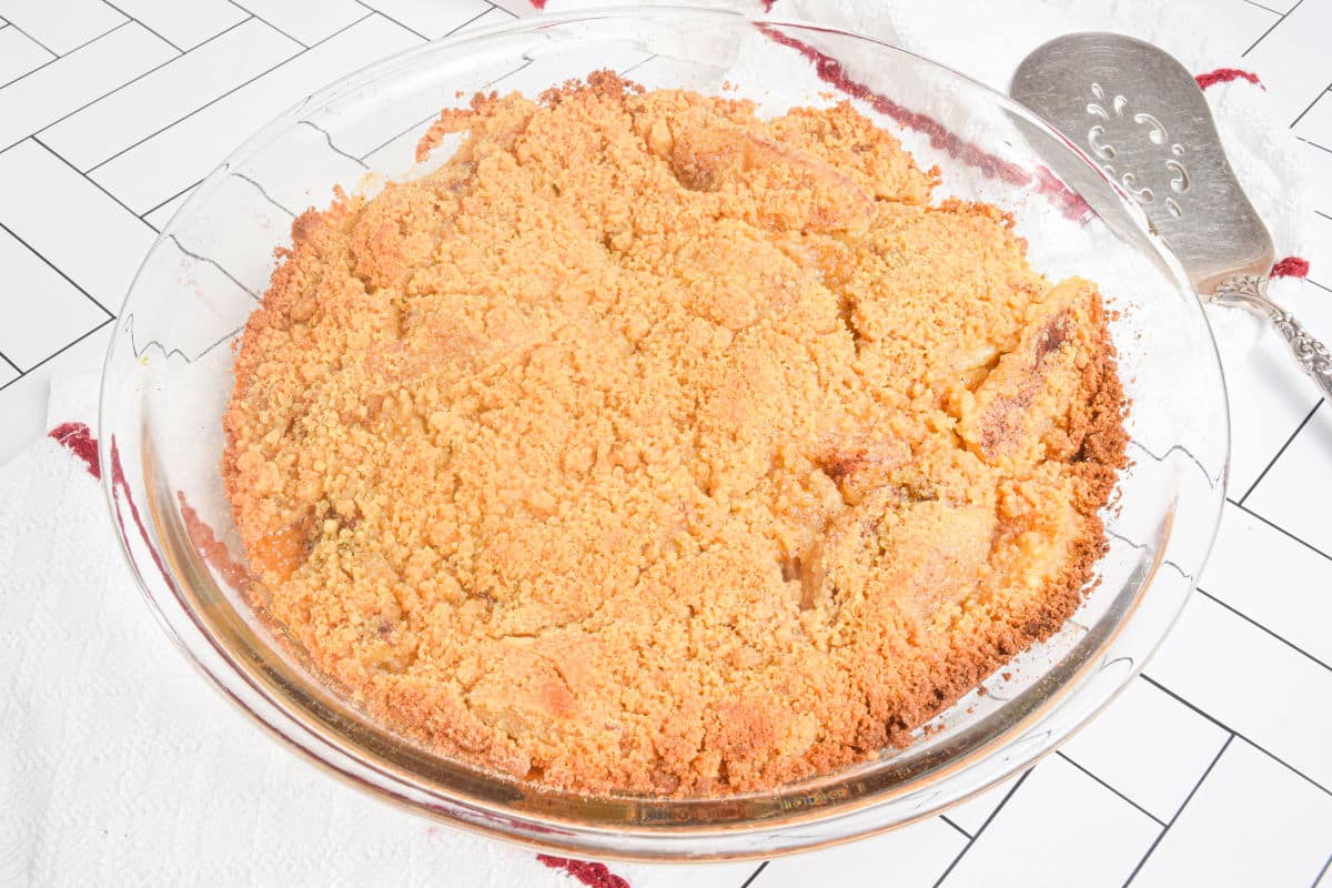 Baked, golden apple crisp in a pie dish.