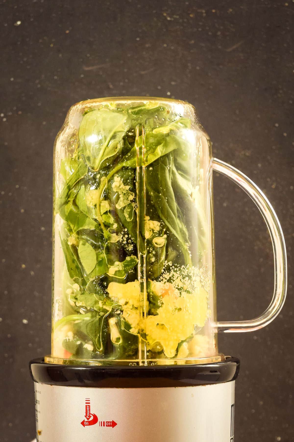 Basil pesto ingredients in a bullet blender.