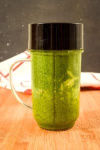Basil pesto in a bullet blender jar.