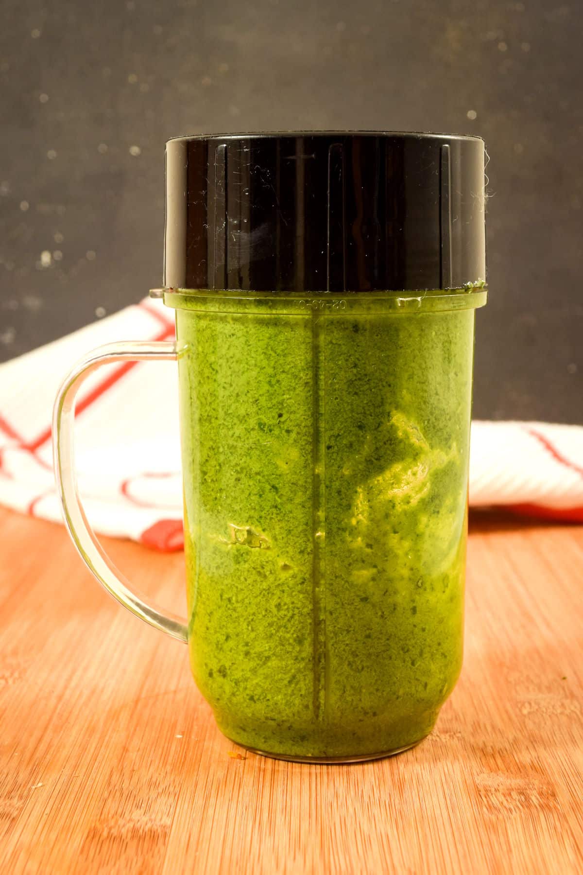 Basil pesto in a bullet blender jar.